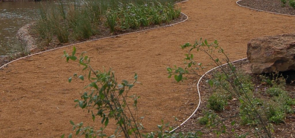 This image depicts an aggregate walkway using Permaloc landscape edging.